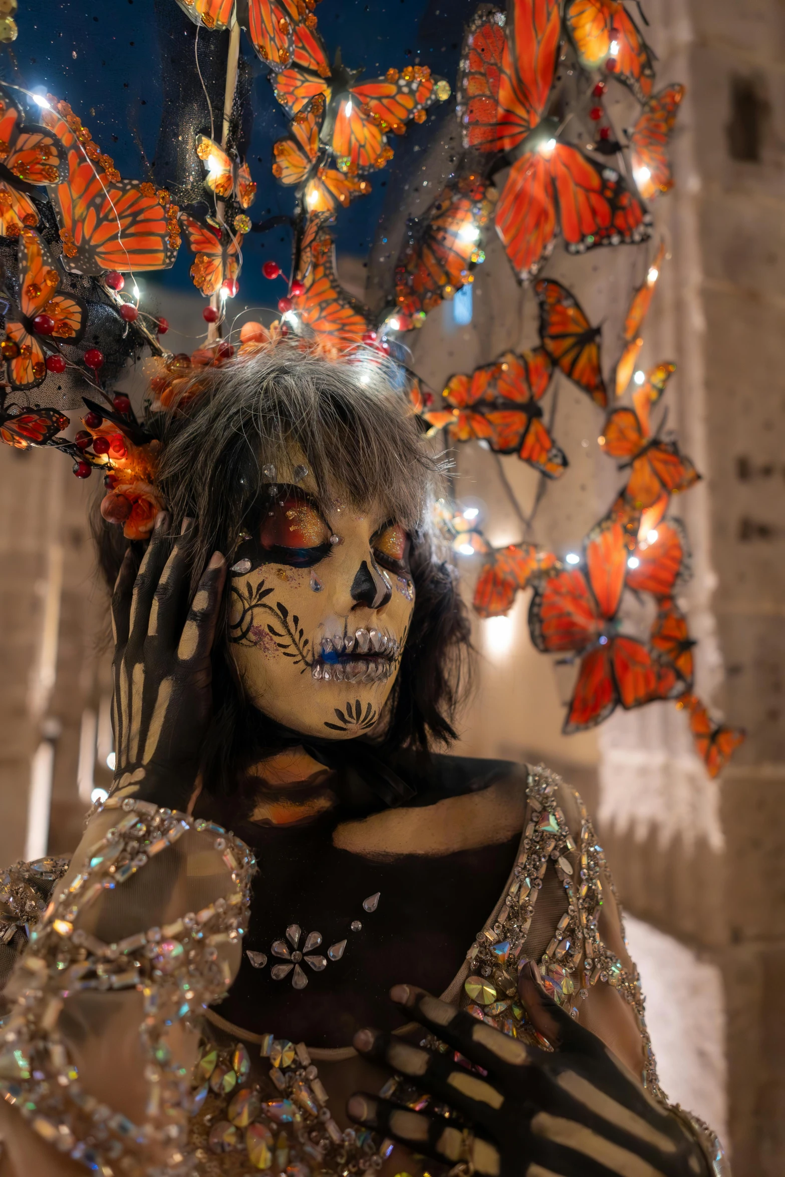 a woman in costume and erflies above her head