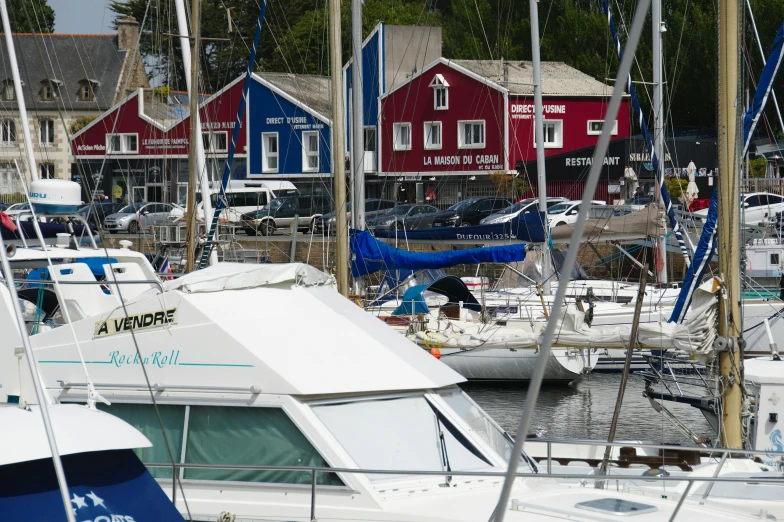 the boats are all docked near houses on the water