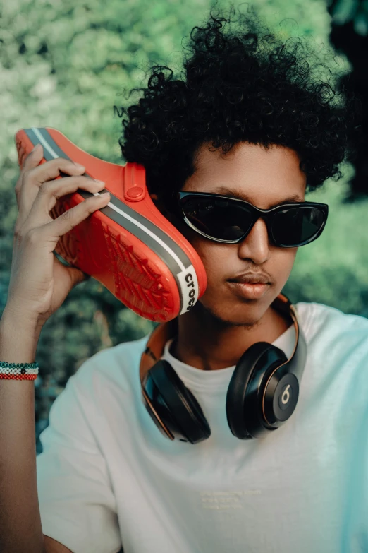 a man with headphones holding up soing