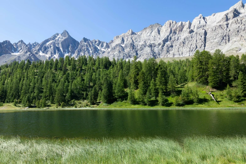 an empty lake surrounded by tall mountains