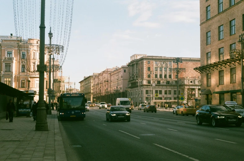 an empty city street lined with tall brown buildings