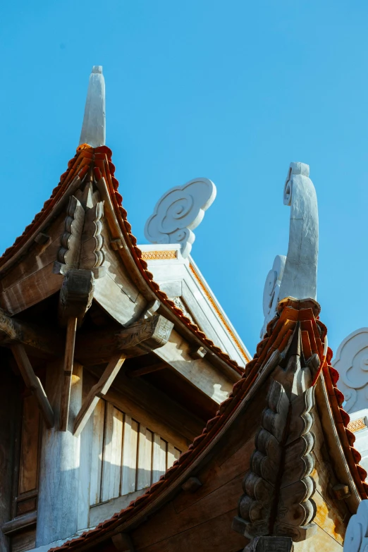 a roof with four white bird shaped windows