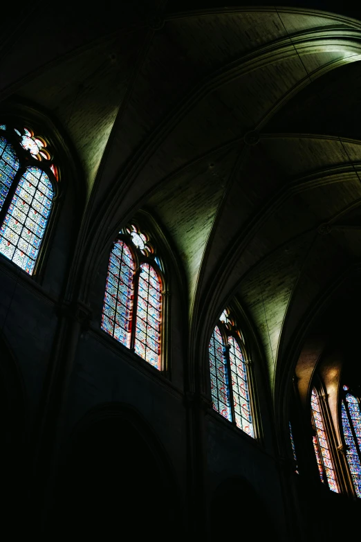 the stained glass windows in the gothic architecture are dark