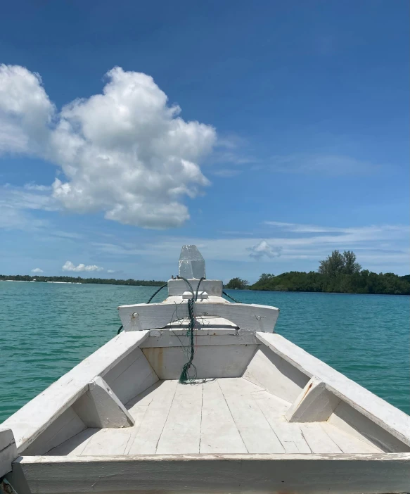 a small boat that is floating on some water