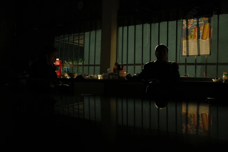 dark image of a person sitting in a dimly lit room