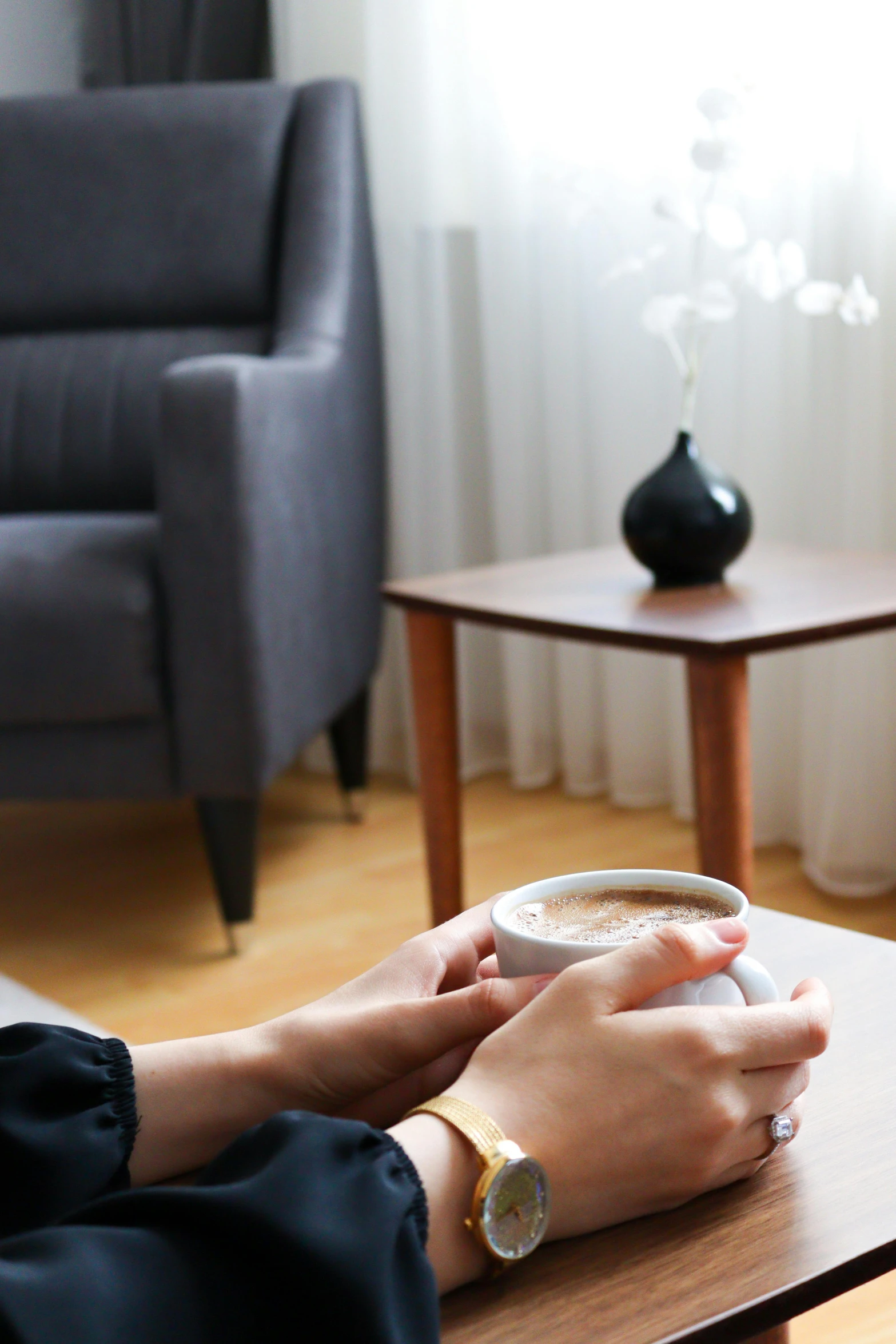 a woman is holding a drink in her hand