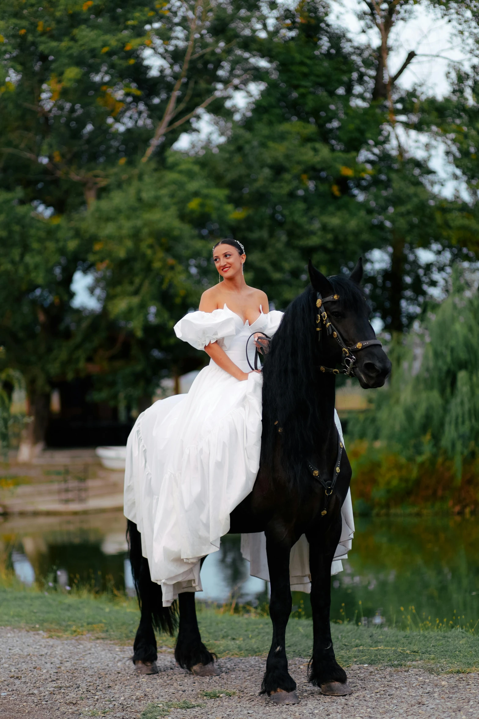 the woman is in the white dress on top of the black horse