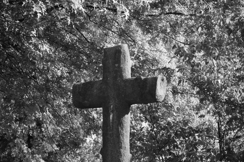 a black and white po of a cross at a cemetery