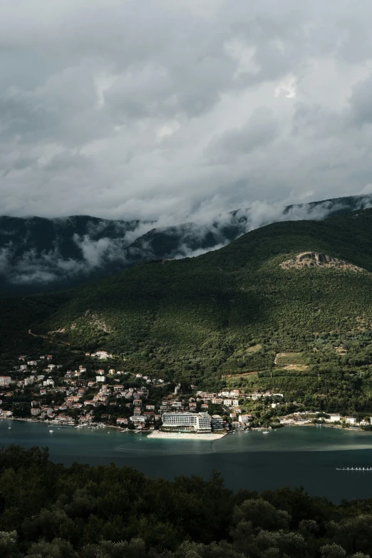 a mountain side town sitting on top of a body of water