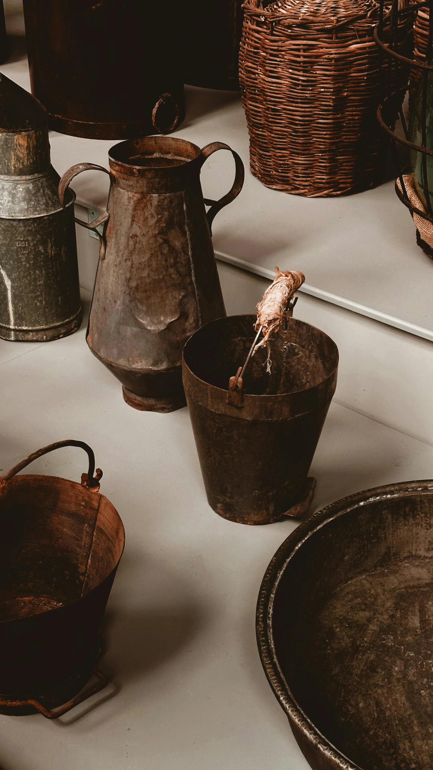 many pots on a counter with some one in it