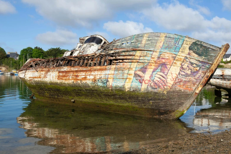 a derelict boat sitting on top of a body of water