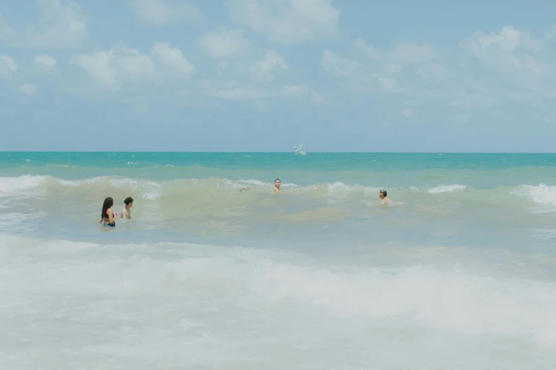 people out in the water at the beach