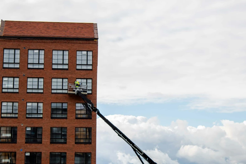 a person standing on the top of a ladder