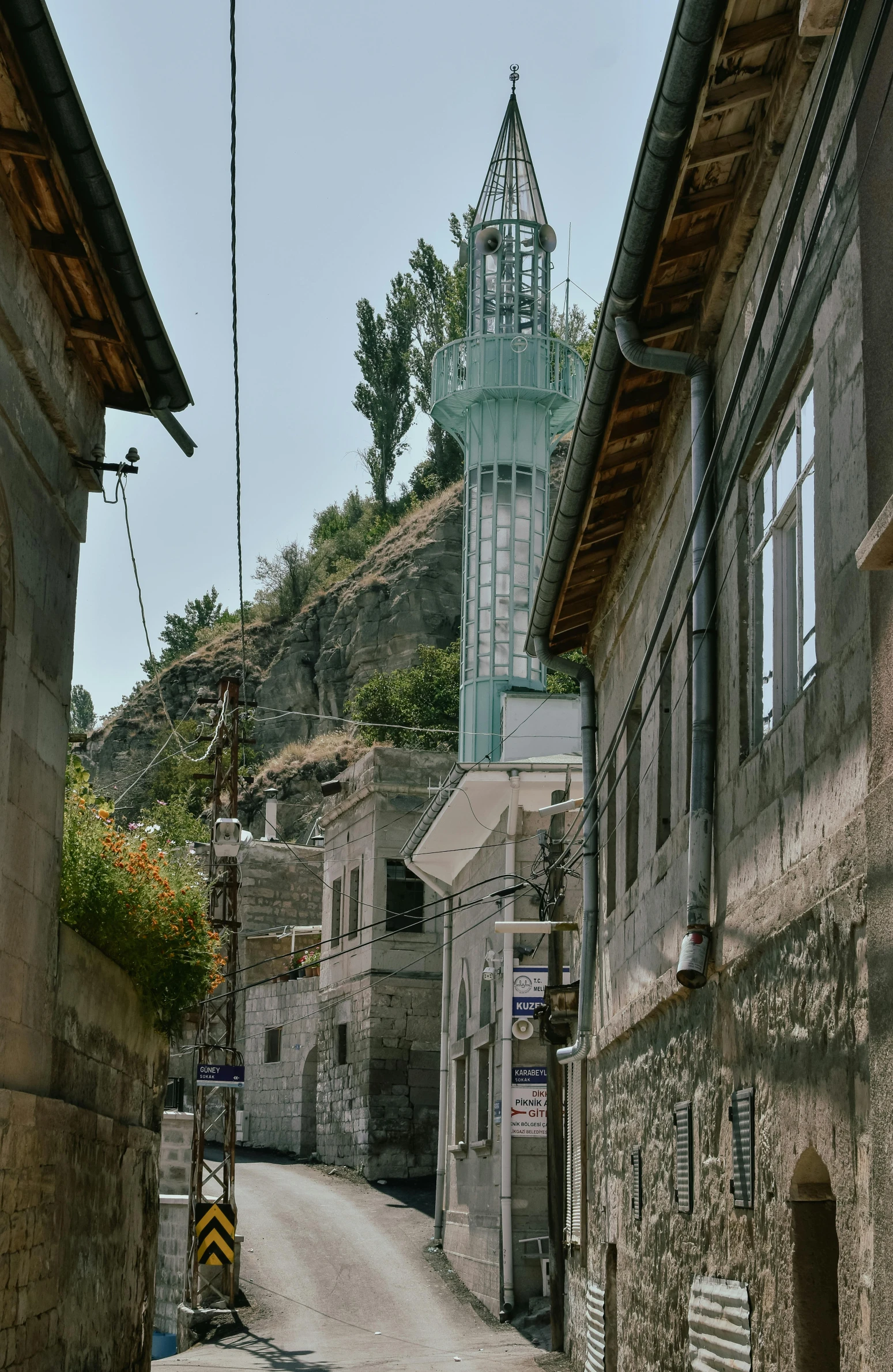 a street that has a tall steeple on the building and a clock tower on top