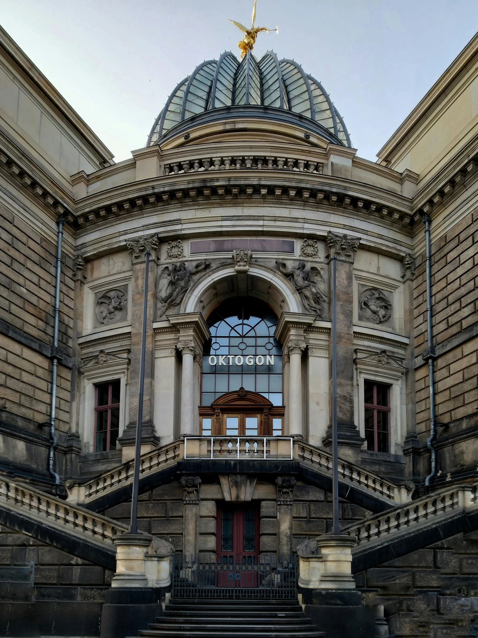 an ornate building with a clock tower and stairs