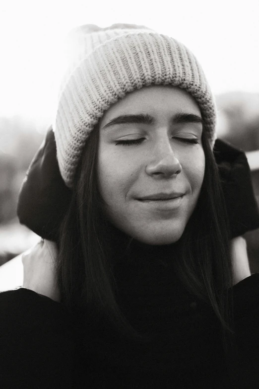 black and white po of a woman wearing a hat