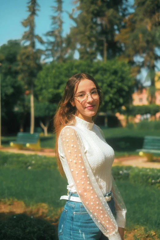 a smiling woman in a white top standing