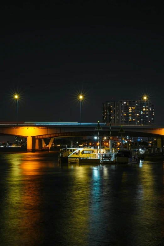 a city and boats on a river at night