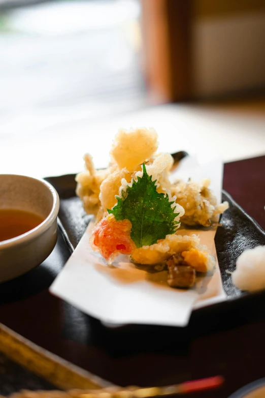 a plate that has food on it and a cup of soup