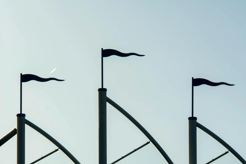 a set of three different flags with their flying tails