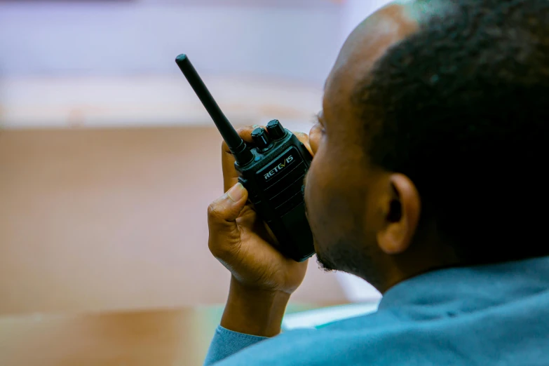 a man using a radio on a sunny day