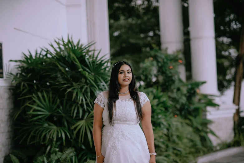 a woman in white is posing for a picture