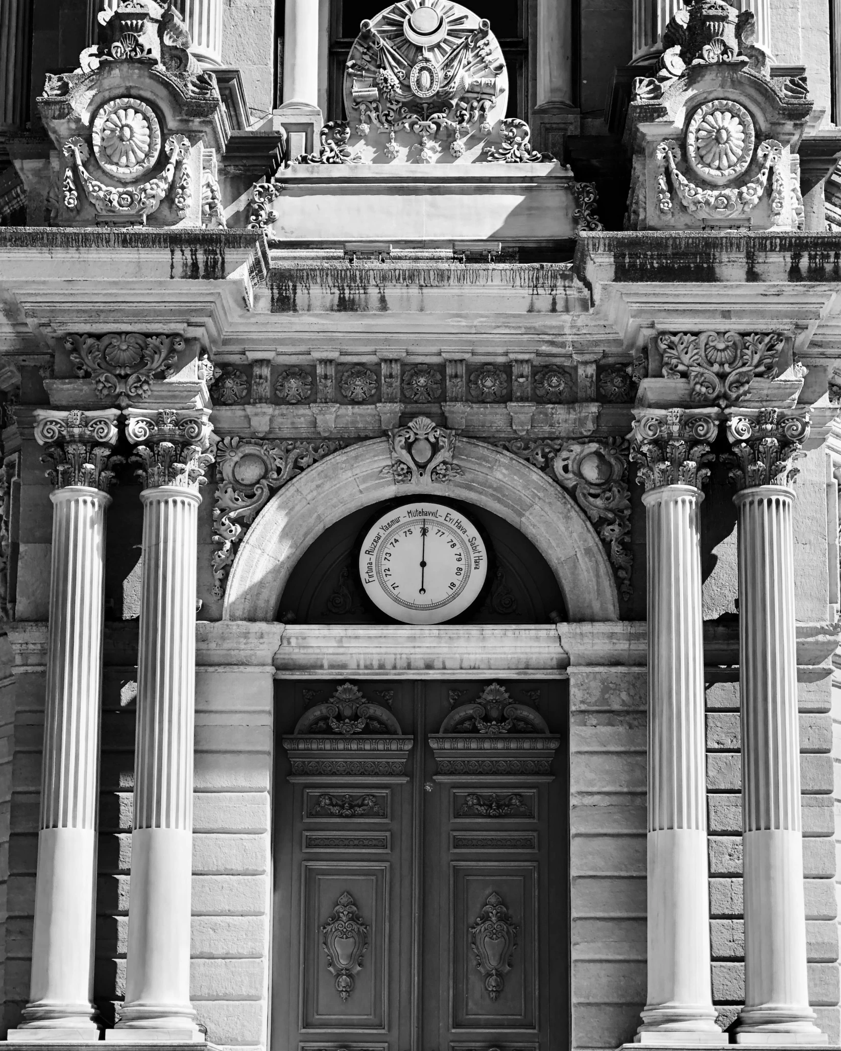 an old black and white po of two columns in front of a door