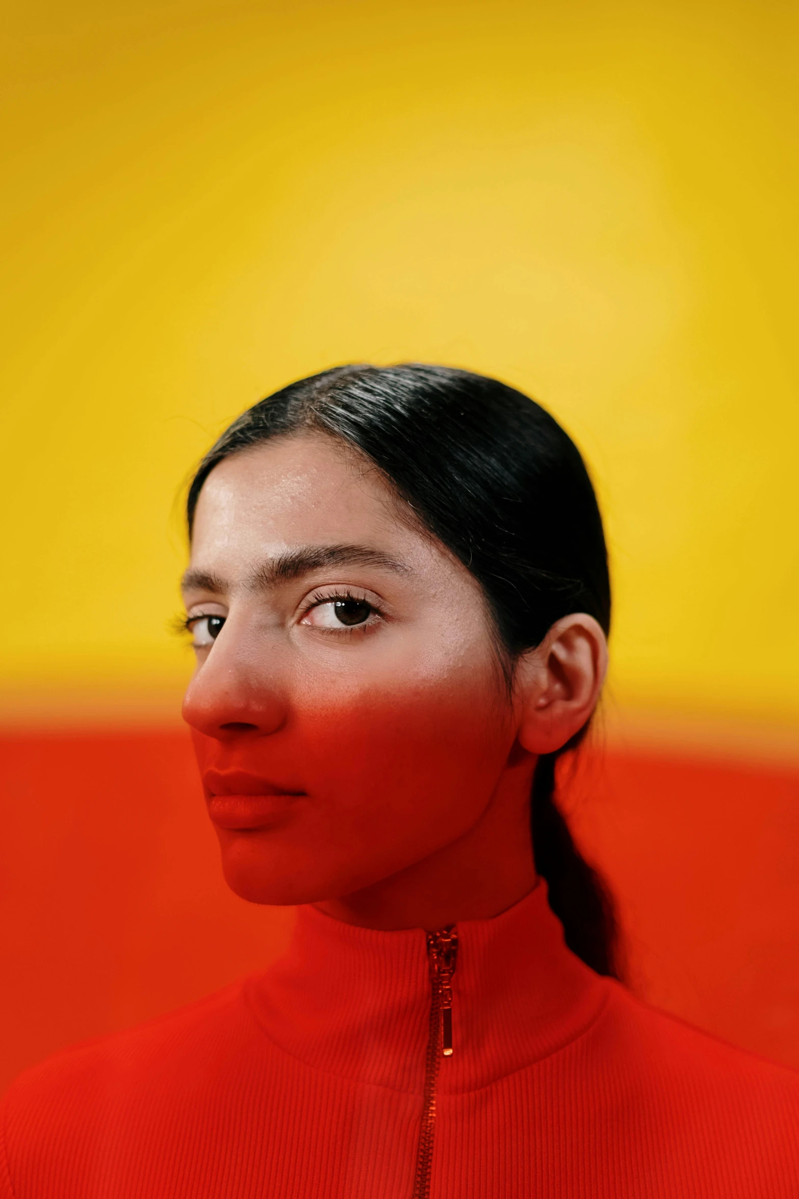 the woman with a bright red shirt has her eyes closed