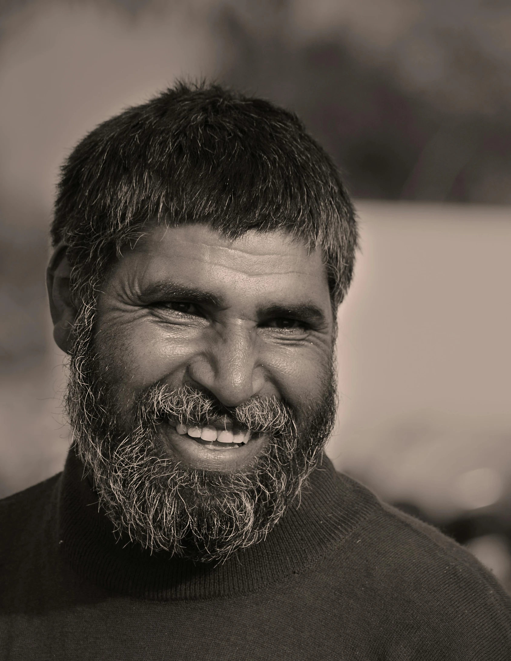 a man with a beard and beard standing in front of a parking lot