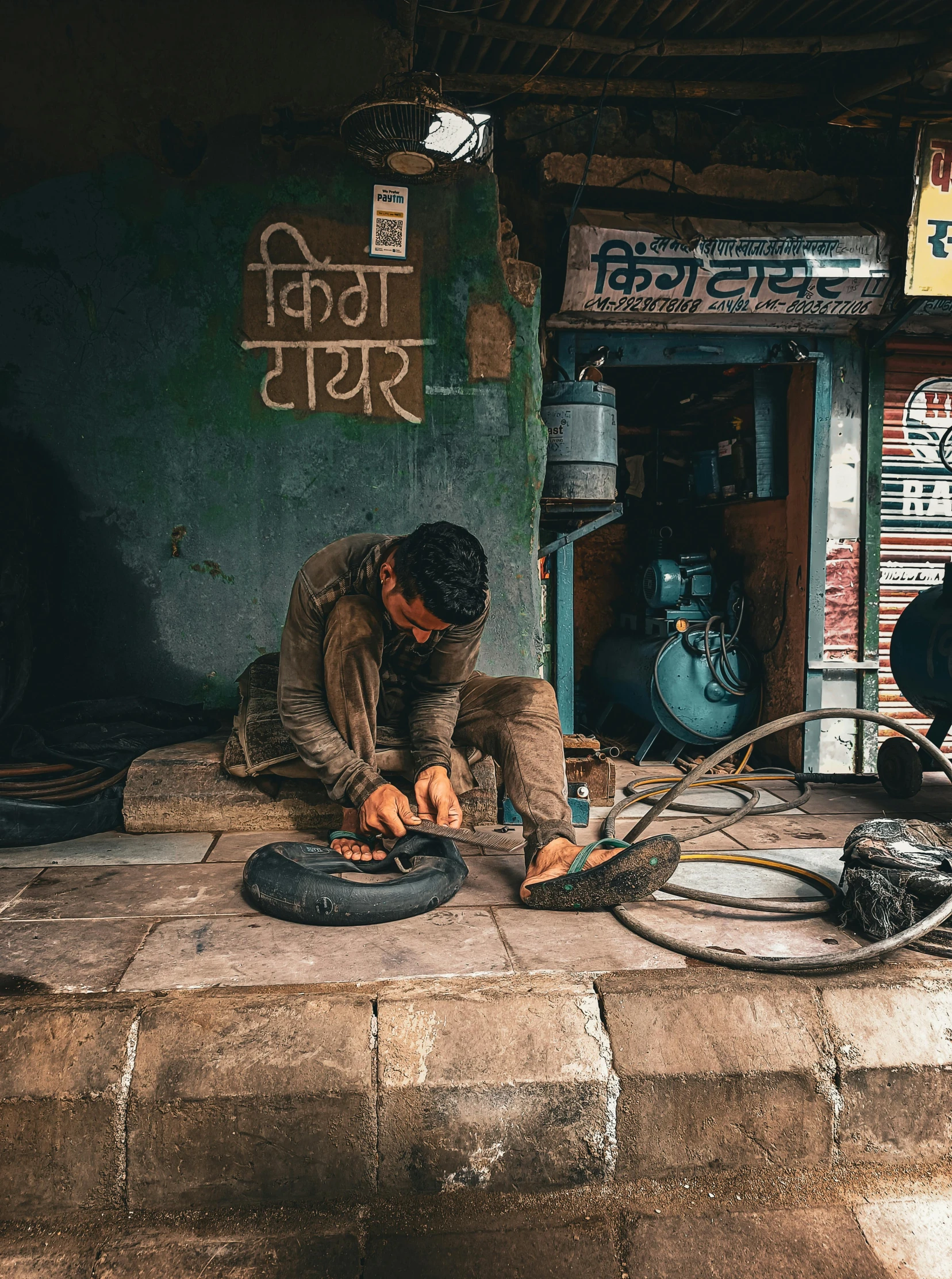 the man works on a wheel with his hands