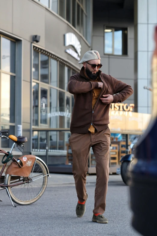 a man is looking at his phone while walking