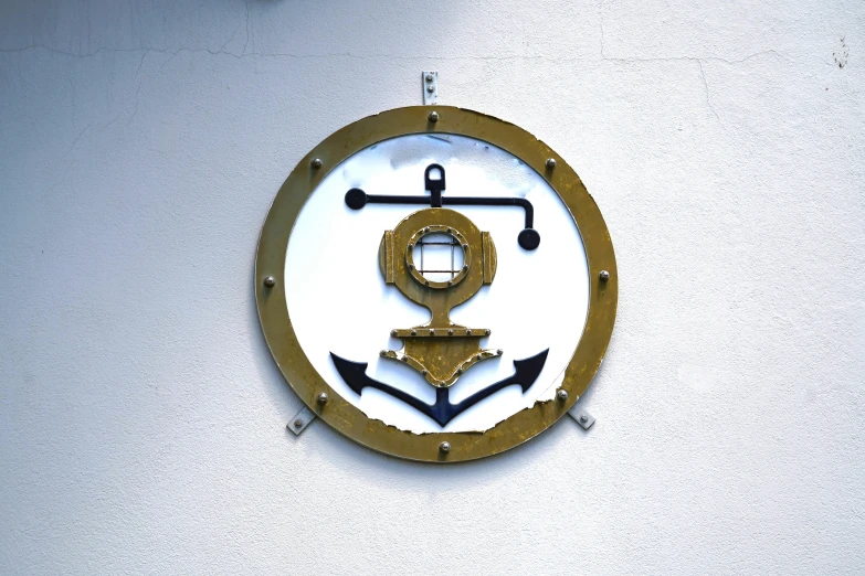 a clock on the wall with an anchor in it