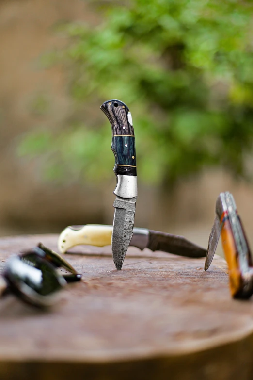 a small knife sits on top of some knives