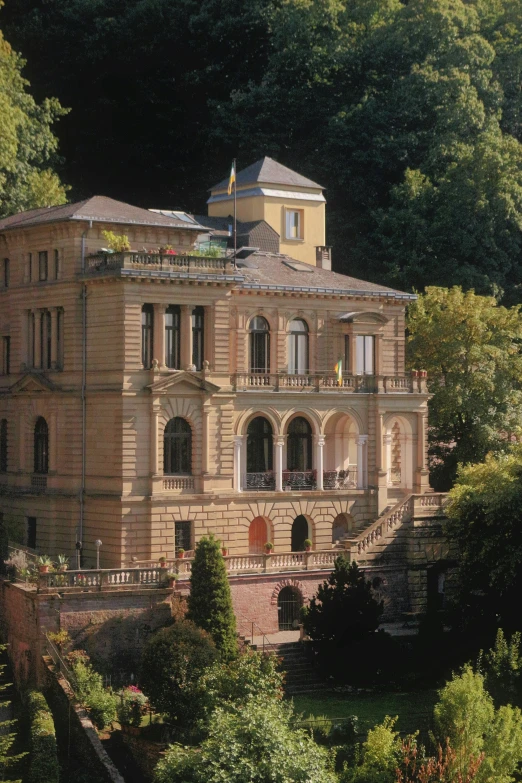 a very big pretty house with some trees around