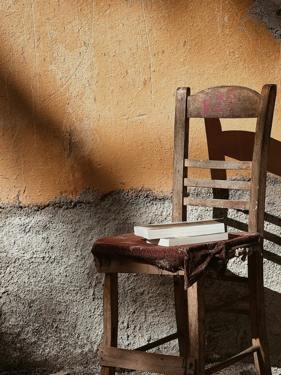 a chair sits on the floor next to a wall