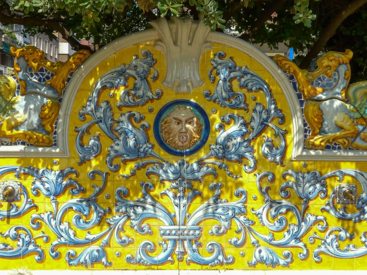 an ornately decorated piece with lots of blue and yellow paint