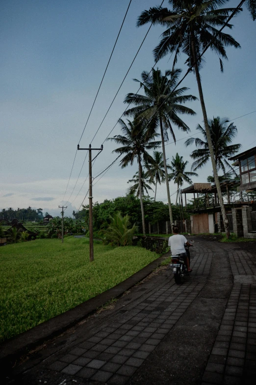 a man walks down the road with an umbrella