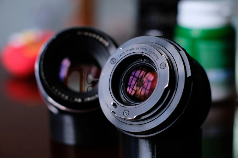 two cameras are sitting next to each other on the table