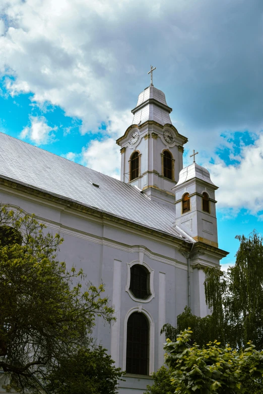 there is a large white church with two windows