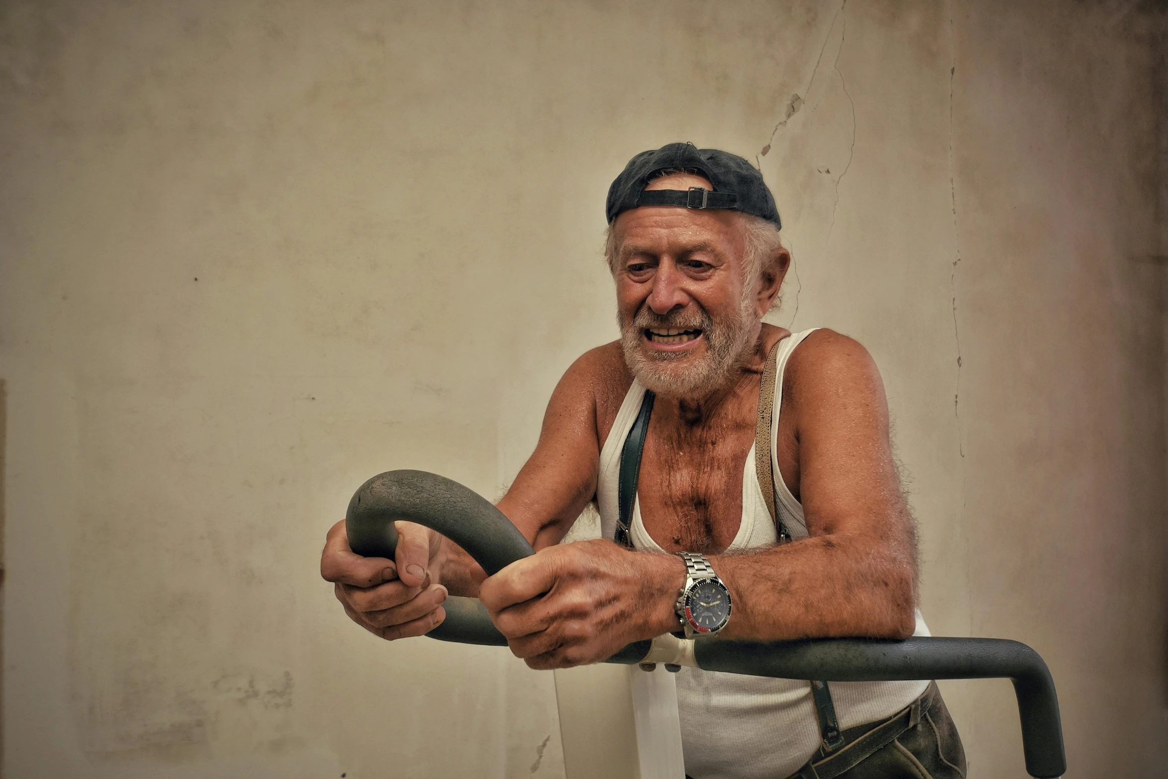 an old man sitting on a bench holding a pipe