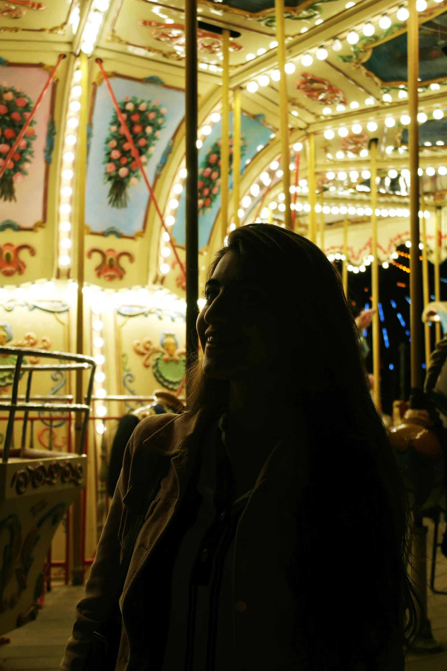 a woman riding the merry go round on an amut park ride