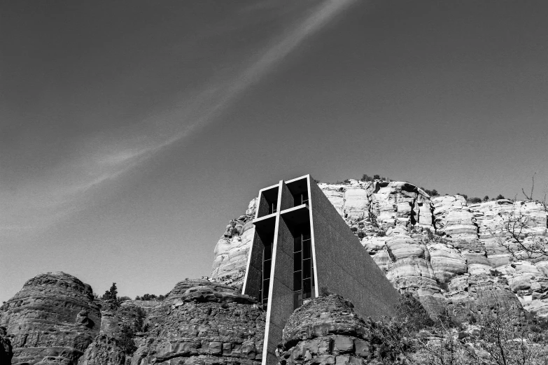 a black and white po of a church steeple and a large cross