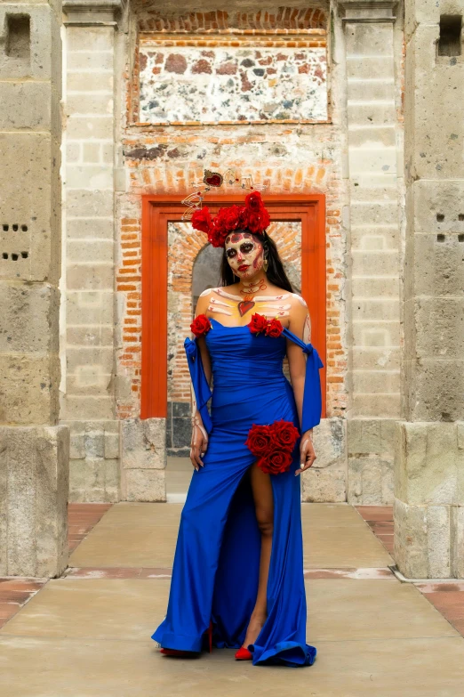 woman in blue dress on street wearing elaborate headpiece