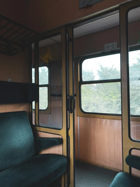 a green seat on a bus looking through the window