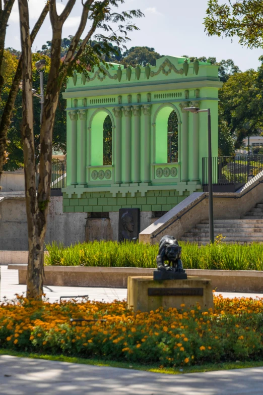 a green building in the middle of a park