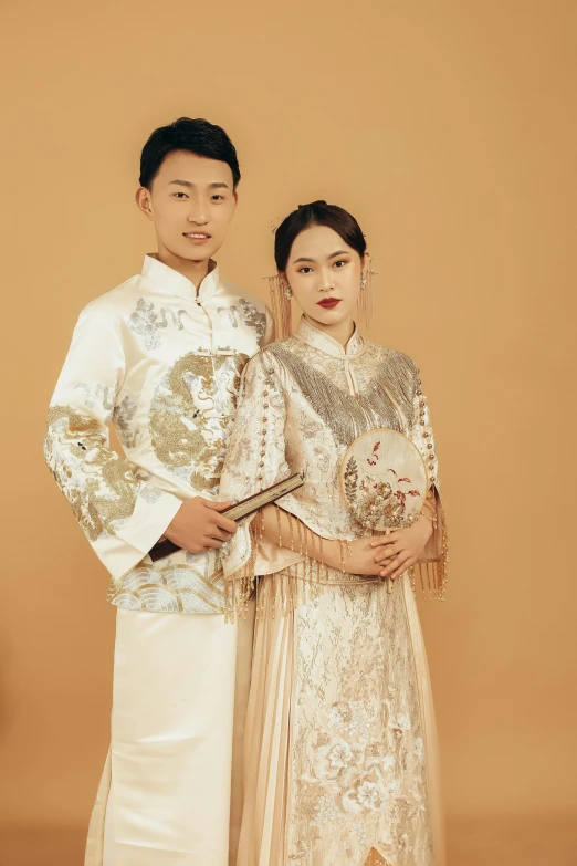 two people dressed in traditional clothes standing next to each other