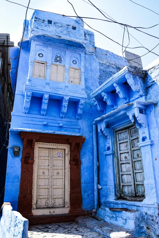 a building with a doorway on the ground in front of buildings