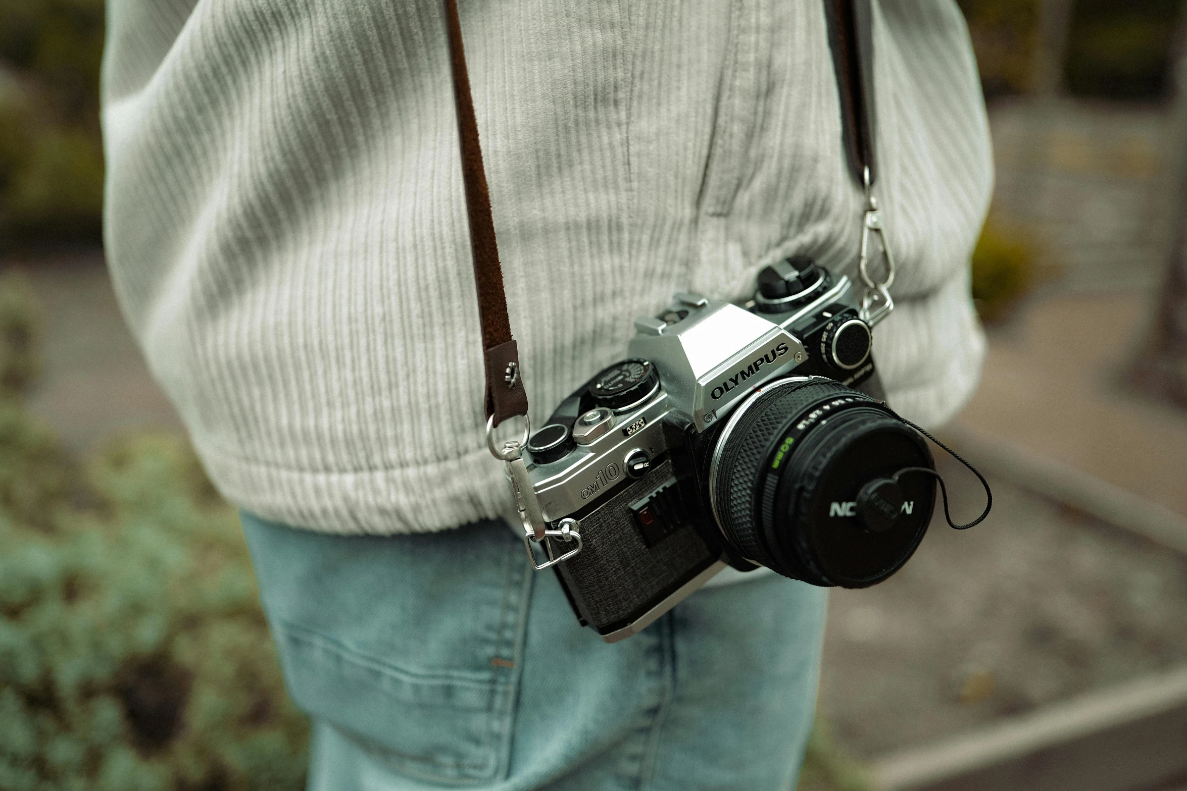 a person holding up a camera in his left hand