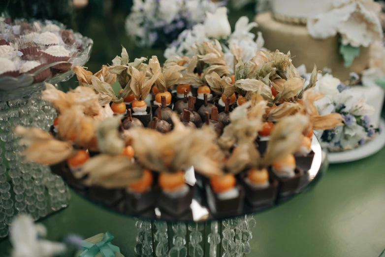 a display plate full of decorated cake, candy and flowers