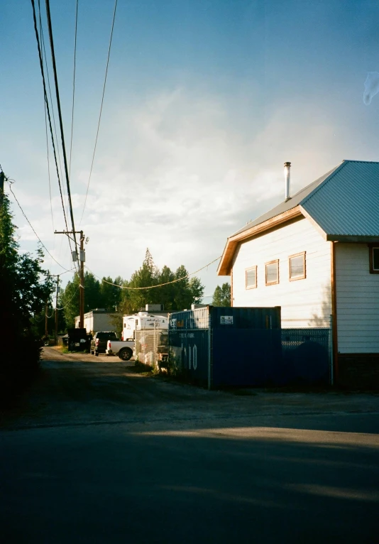 two houses with utility trucks parked on the side of a street